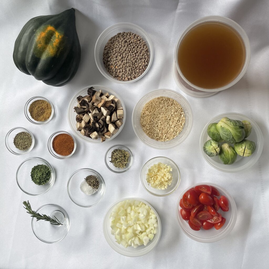 A birds-eye shot of all of the ingredients required for the stuffed acorn squash recipe.
